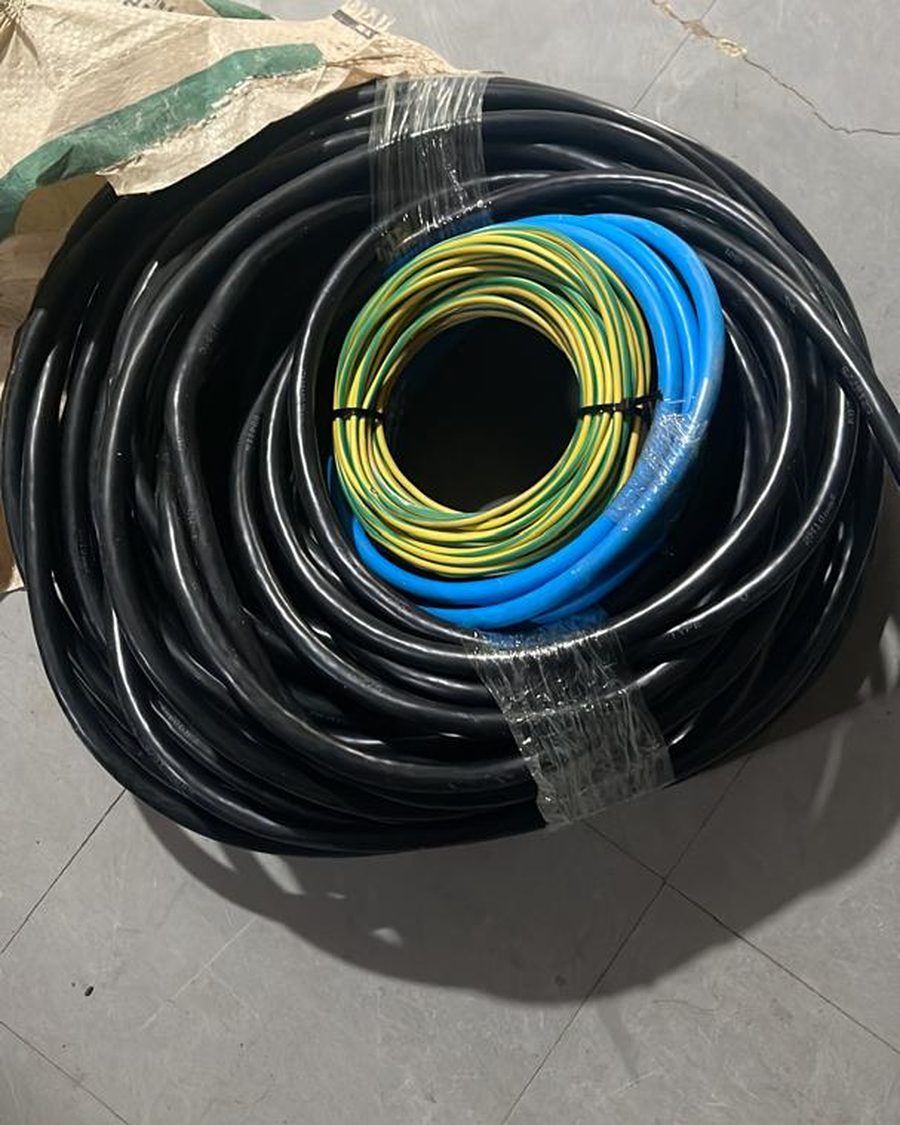 Coils of armoured, blue and earth cable staged for an installation.