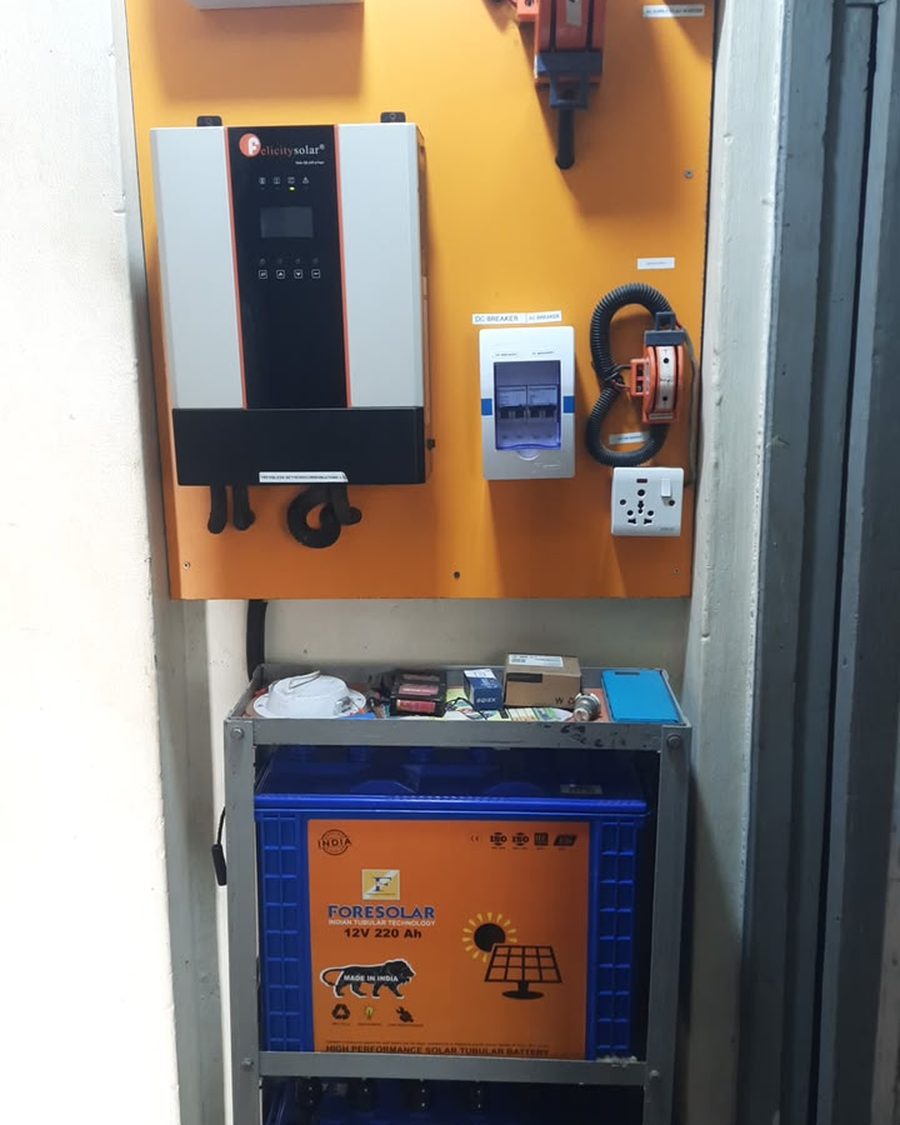 A completed control board with a Felicity Solar inverter, breakers and battery bank.